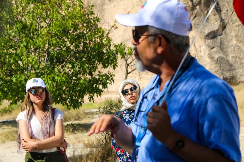 Guide briefing guests among the valleys on the bookable Cappadocia Red Tour from The Owl Cave Hotel, Göreme