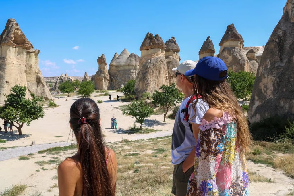 Guests overlooking Paşabağ fairy chimneys on the bookable Cappadocia Red Tour from The Owl Cave Hotel, Göreme