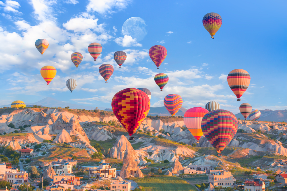 Colorful hot air balloons over Göreme village at sunrise on the bookable Göreme Sunrise Balloon Flight from The Owl Cave Hotel, Cappadocia