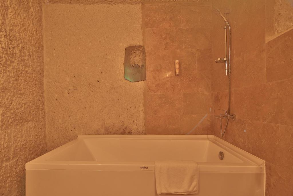 Private bathroom with bath in the Cave Suite at The Owl Cave Hotel, Göreme, Cappadocia