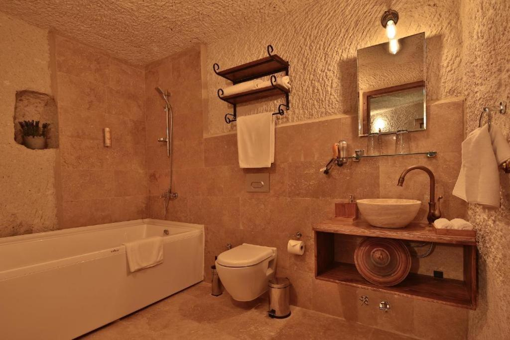 Private bathroom with bath and shower in the bookable Family Suite at The Owl Cave Hotel, Göreme, Cappadocia